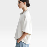 JONES + CO Rachel Comey Fond sweatshirt in dirty white with drop shoulders, cropped sleeves, and raw edge hemline.