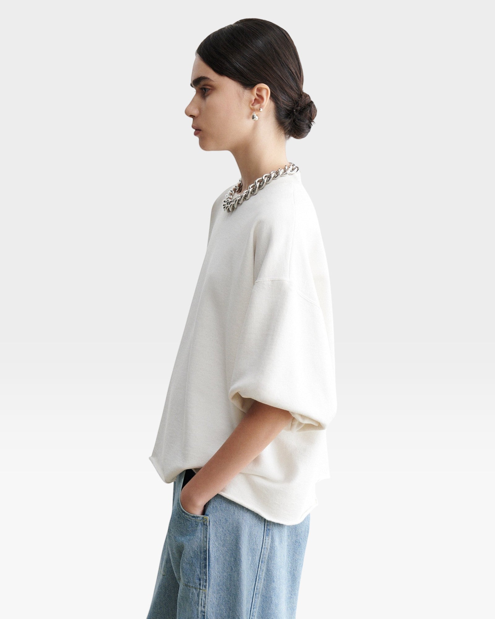 JONES + CO Rachel Comey Fond sweatshirt in dirty white with drop shoulders, cropped sleeves, and raw edge hemline.