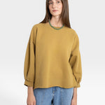 JONES + CO Fond Sweatshirt in tapenade green with raw hem, drop shoulders, and cropped sleeves.