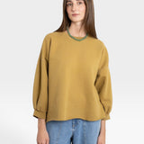 JONES + CO Fond Sweatshirt in tapenade green with raw hem, drop shoulders, and cropped sleeves.