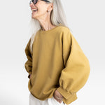 JONES + CO Fond Sweatshirt in tapenade yellow. Crewneck, drop shoulders, raw hem, distressed details.
