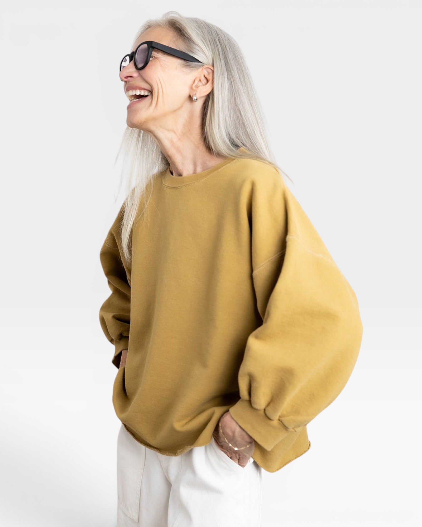 JONES + CO Fond Sweatshirt in tapenade yellow. Crewneck, drop shoulders, raw hem, distressed details.