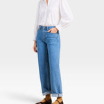 JONES + CO Francesca white voile blouse with oversized collar, pintucked placket, and ruffled cuffs on a model.