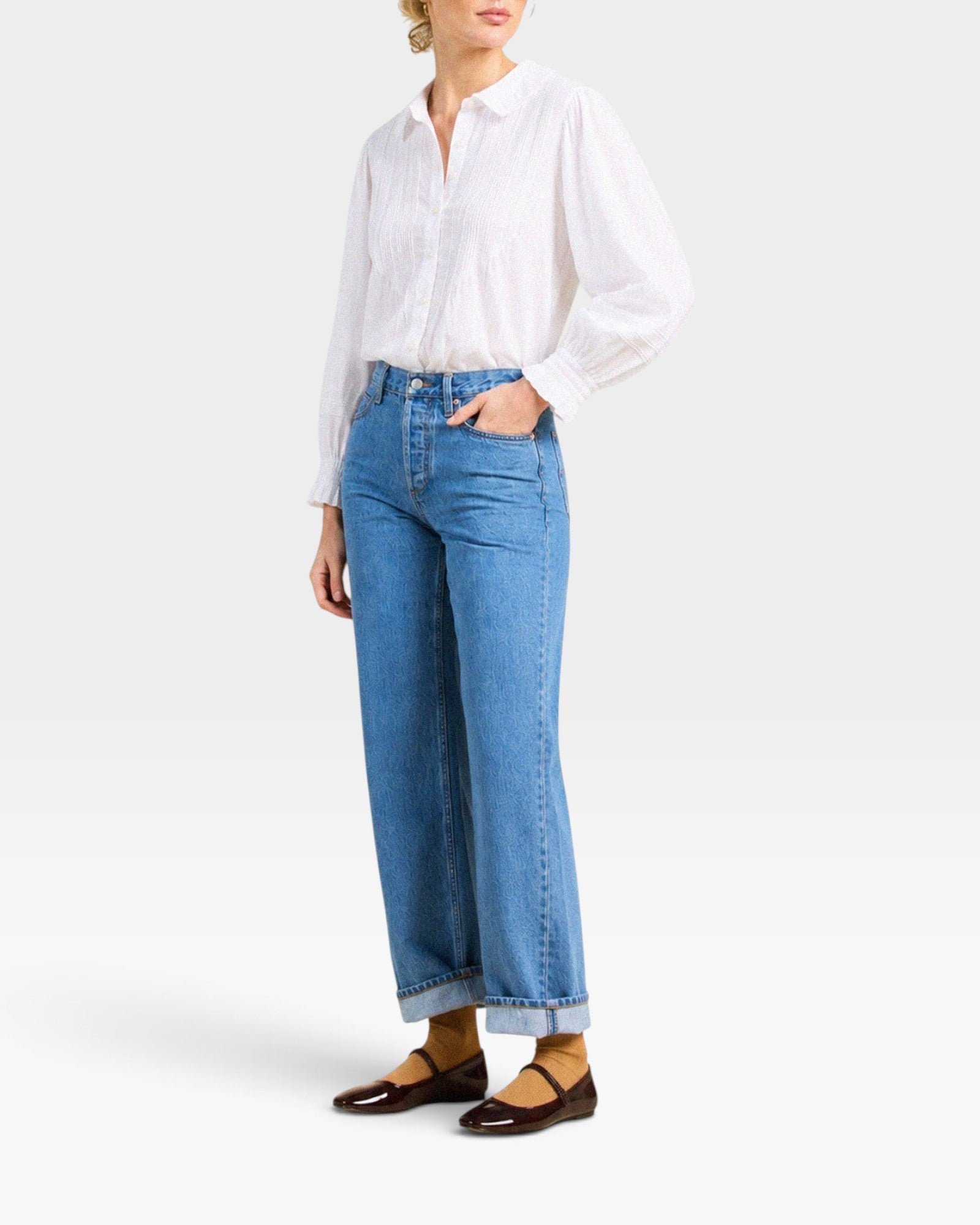 JONES + CO Francesca white voile blouse with oversized collar, pintucked placket, and ruffled cuffs on a model.