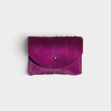 JONES + CO fuchsia cowhide cardholder with a solid brass fastener, featuring a textured hair-on-hide finish.