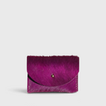 JONES + CO fuchsia cowhide cardholder with a solid brass fastener, featuring a textured hair-on-hide finish.