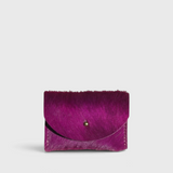 JONES + CO fuchsia cowhide cardholder with a solid brass fastener, featuring a textured hair-on-hide finish.