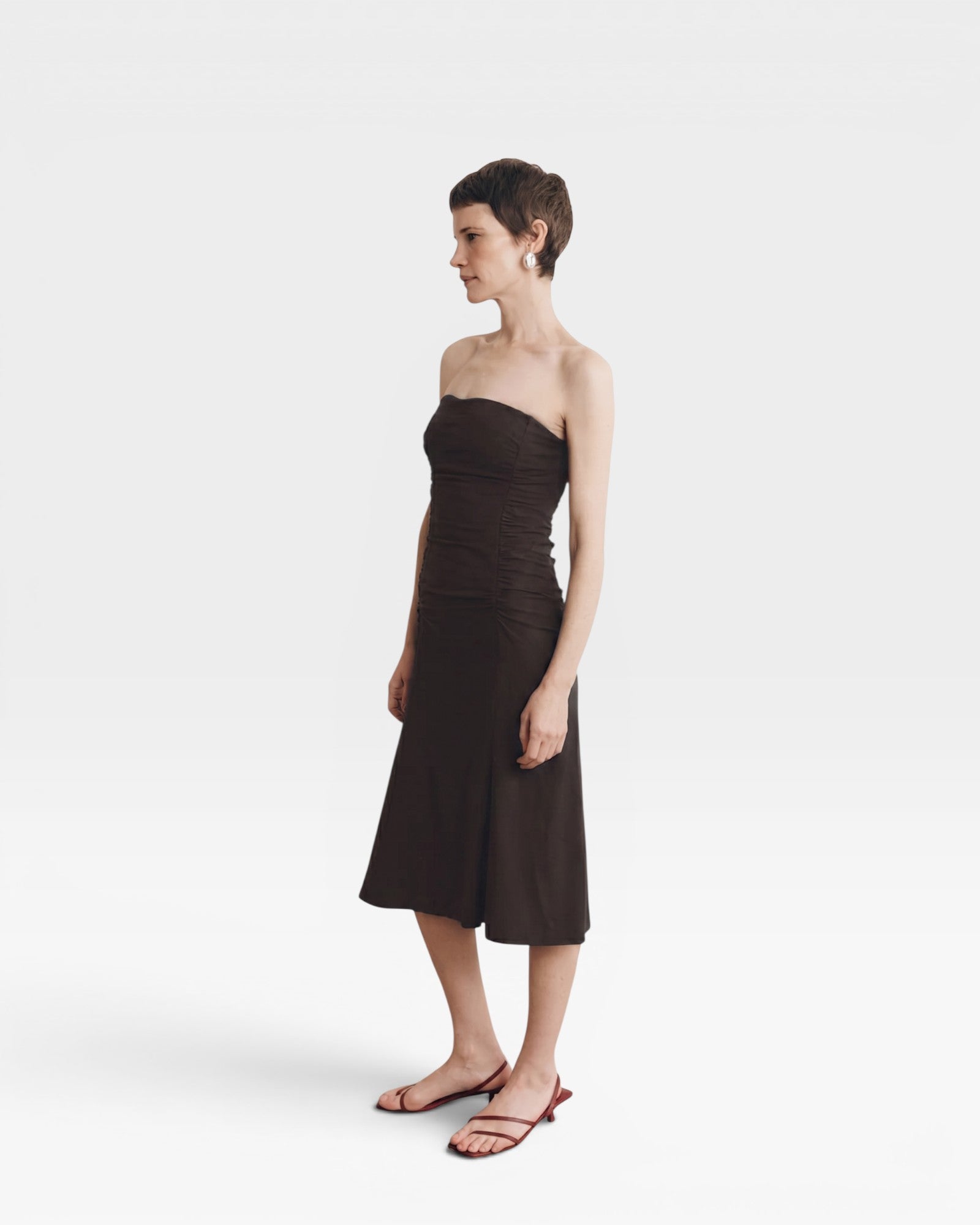JONES + CO Gaia strapless midi dress in espresso. A-line skirt, ruched bodice, and a flattering silhouette.