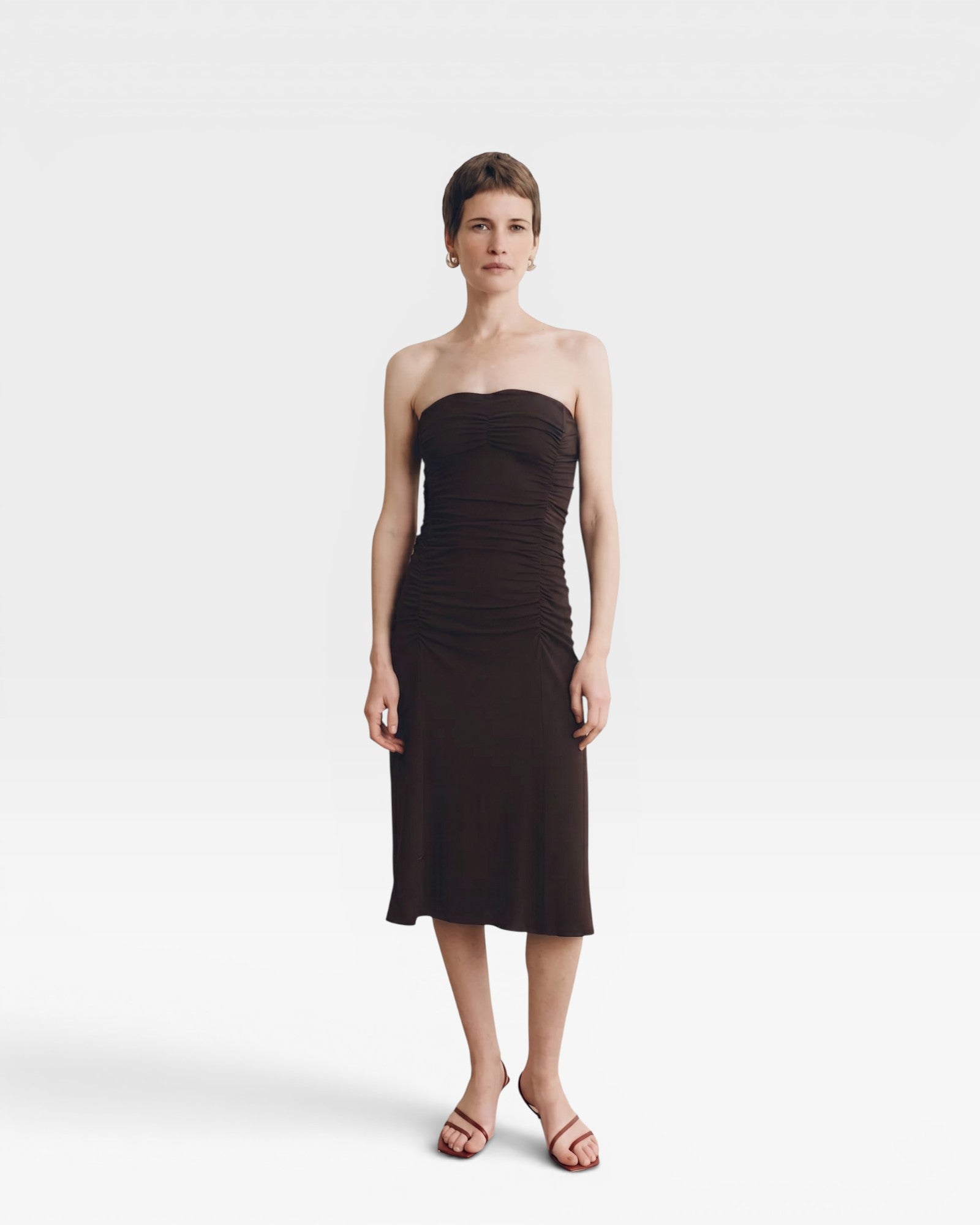 JONES + CO Gaia strapless midi dress in espresso. Fitted silhouette with ruched detailing on the side.