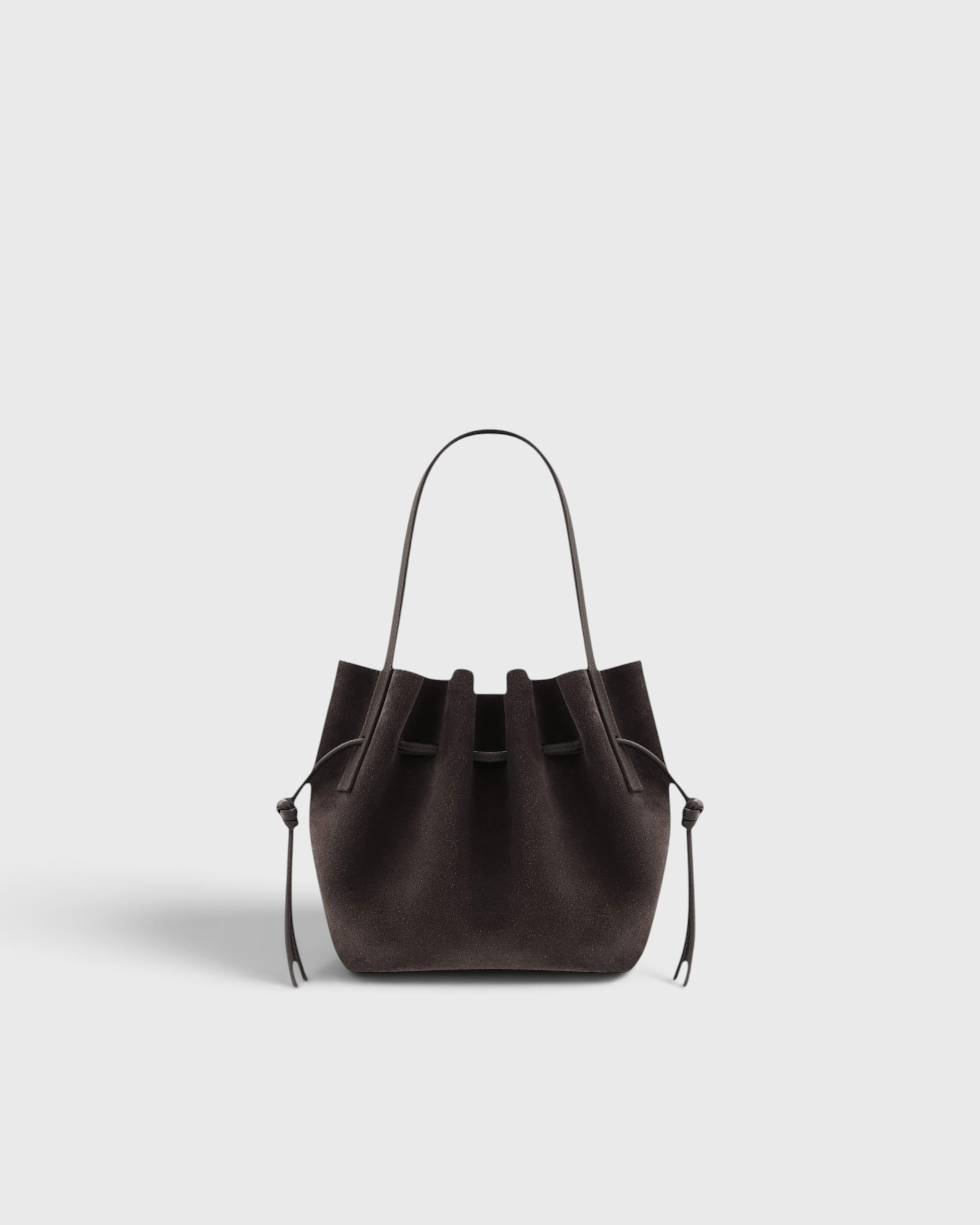JONES + CO Mini Scallop Tote in dark brown ganache suede with a sculptural silhouette and silver-tone hardware.