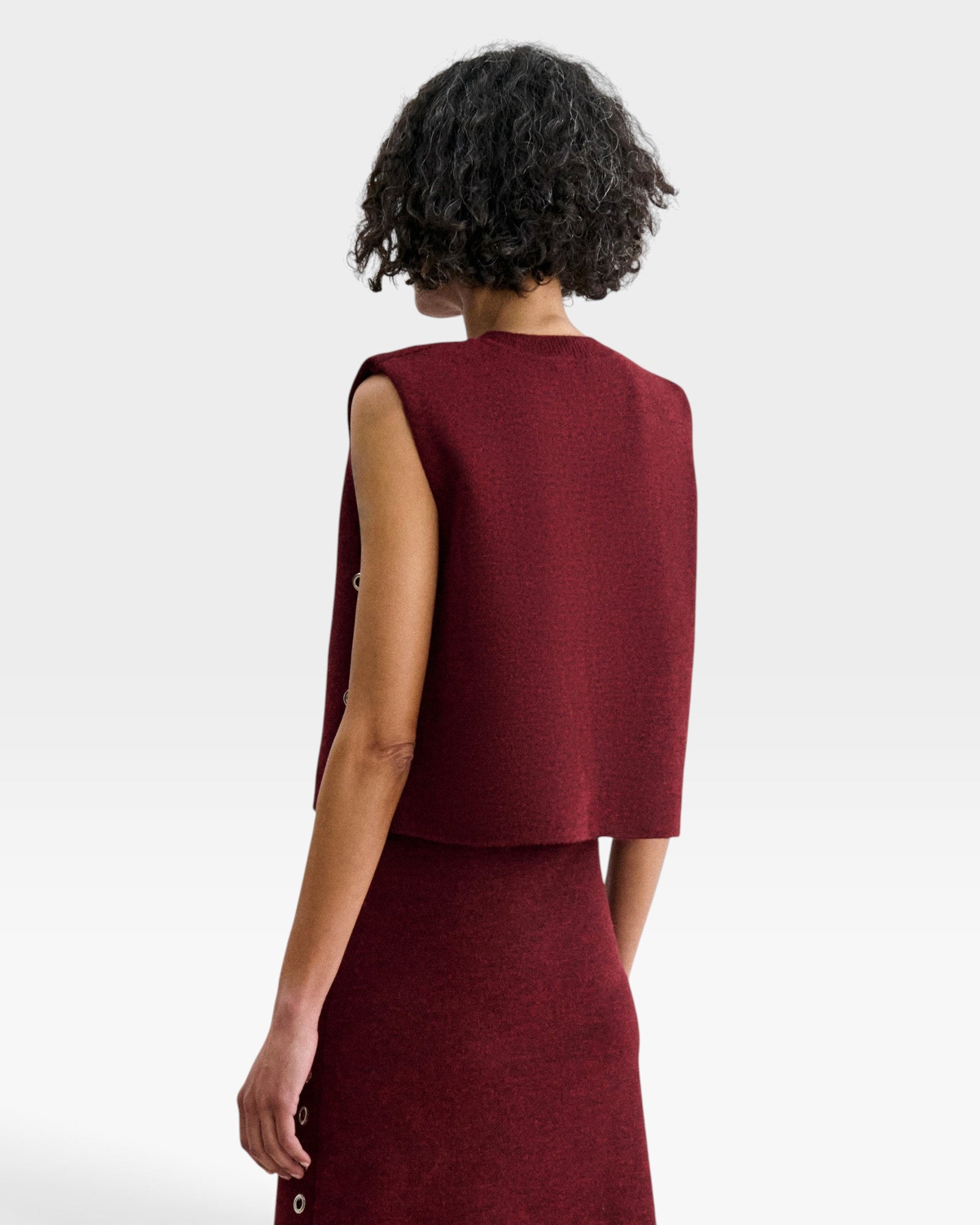 JONES + CO garnet baby alpaca Vega vest with structured boxy silhouette and metallic eyelet details on side