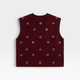 JONES + CO Vega knit vest in garnet red with a boxy silhouette, crew neckline, and metallic eyelet hardware.