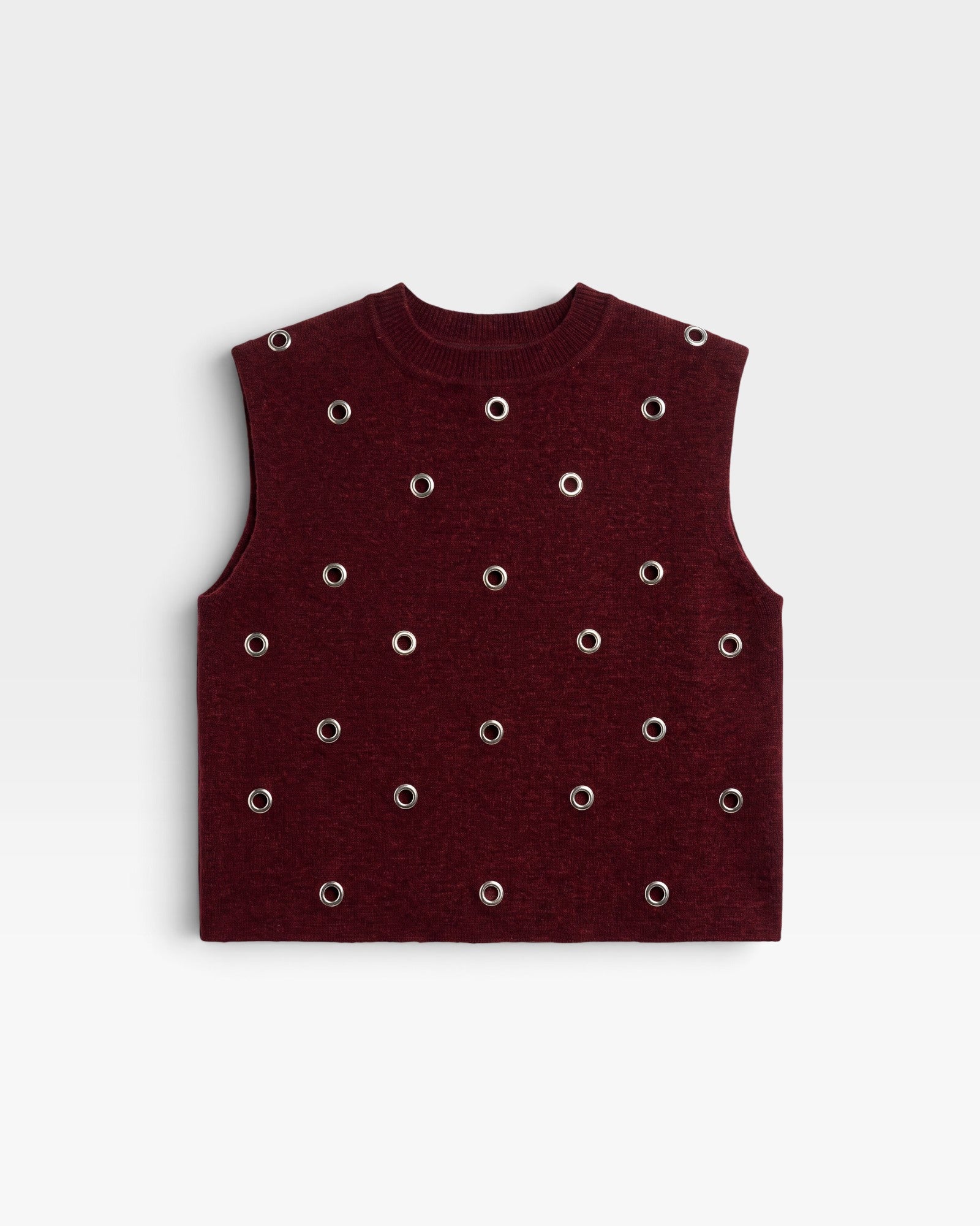 JONES + CO Vega knit vest in garnet red with a boxy silhouette, crew neckline, and metallic eyelet hardware.