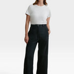 Model wearing JONES + CO black high-waisted Garra jeans in Salinas denim with a relaxed wide-leg fit.