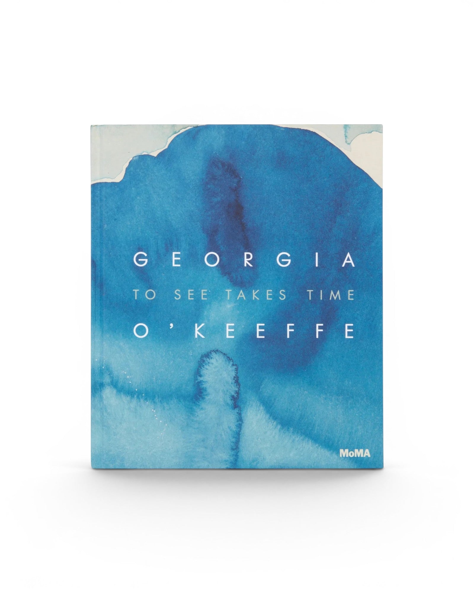 JONES + CO Georgia O’Keeffe: To See Takes Time art book featuring a blue watercolor abstract cover design.