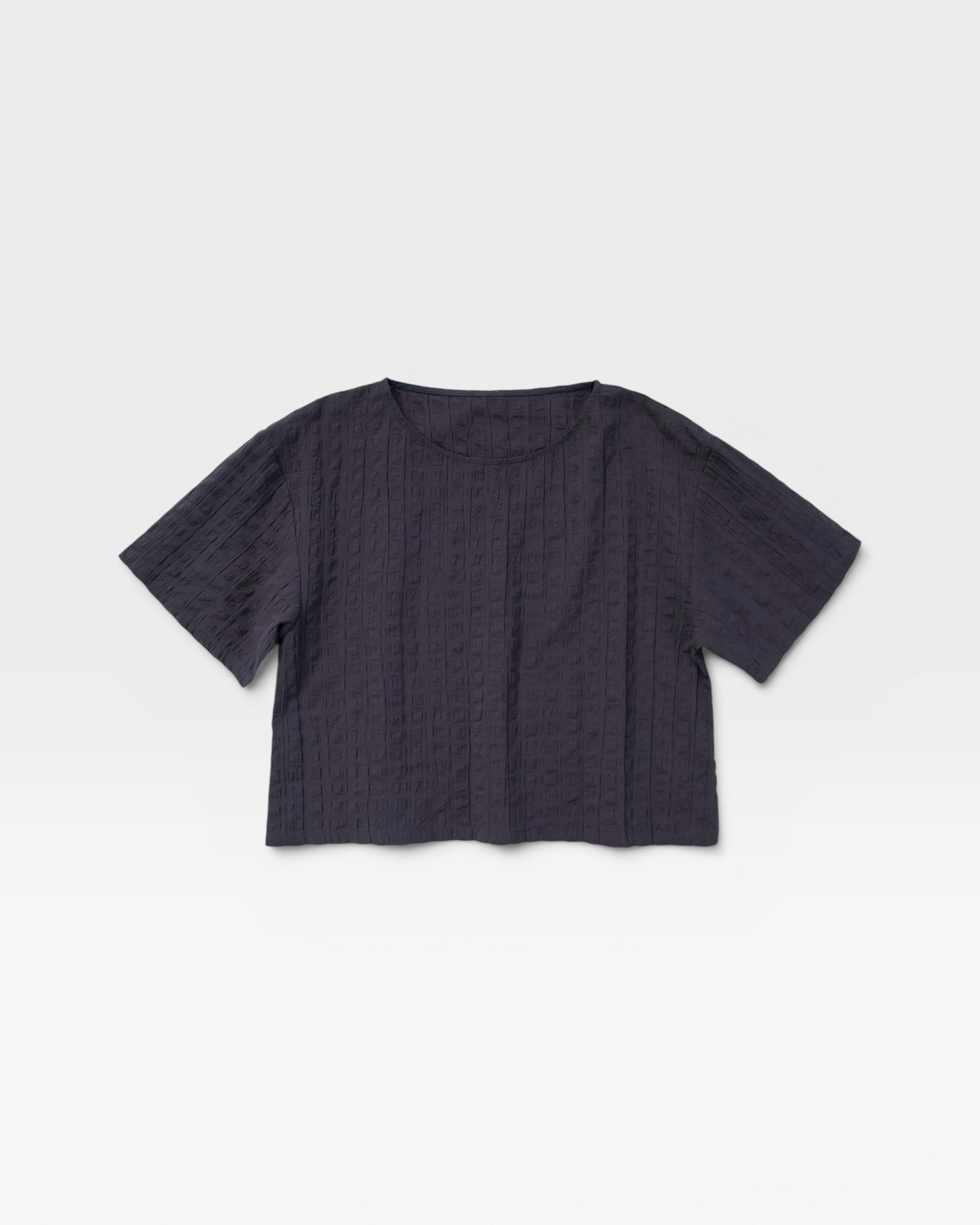 JONES + CO Georgia Tee in faded black crinkle seersucker cotton with a boxy cropped fit and rounded neckline.