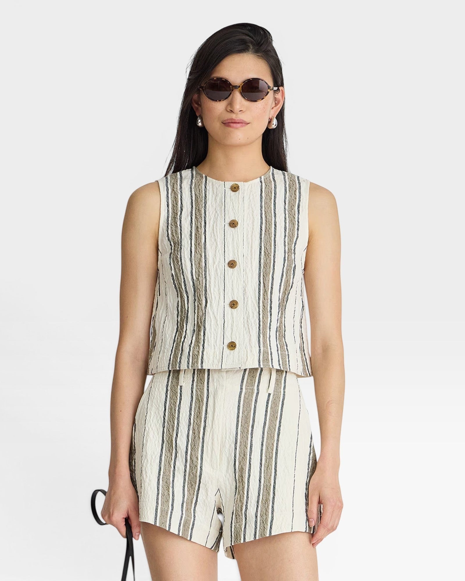 JONES + CO Godet Stripe Tank in off-white with vertical stripes of brown and grey. Button front, sleeveless design.