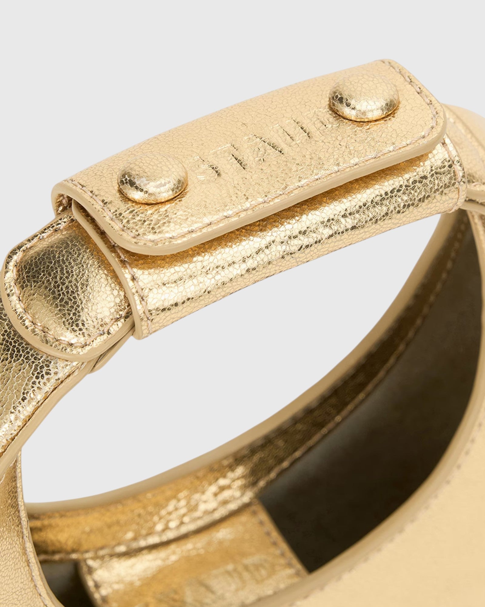 JONES + CO Good Night Moon evening bag in polished gold leather with a crescent silhouette and detachable strap