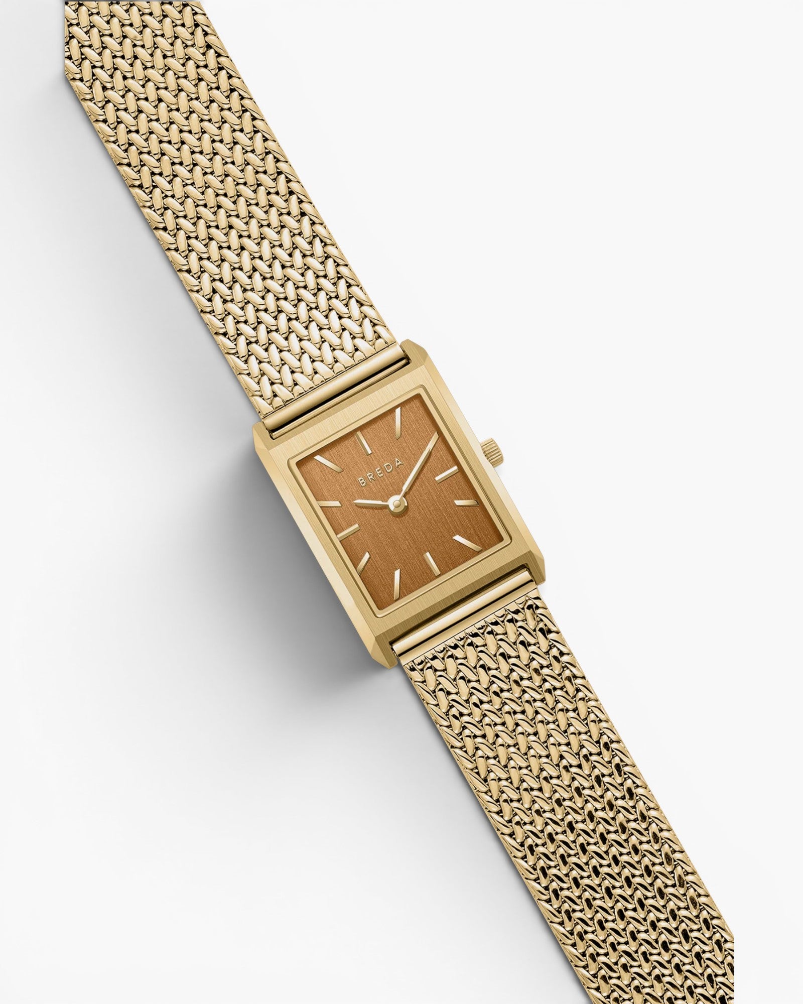JONES + CO Virgil Small watch with a gold rectangle case, ochre dial, and woven mesh bracelet on a white background.
