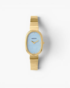JONES + CO Jane watch with a 23mm gold oval case, sky blue mother-of-pearl dial, and gold-plated link bracelet.