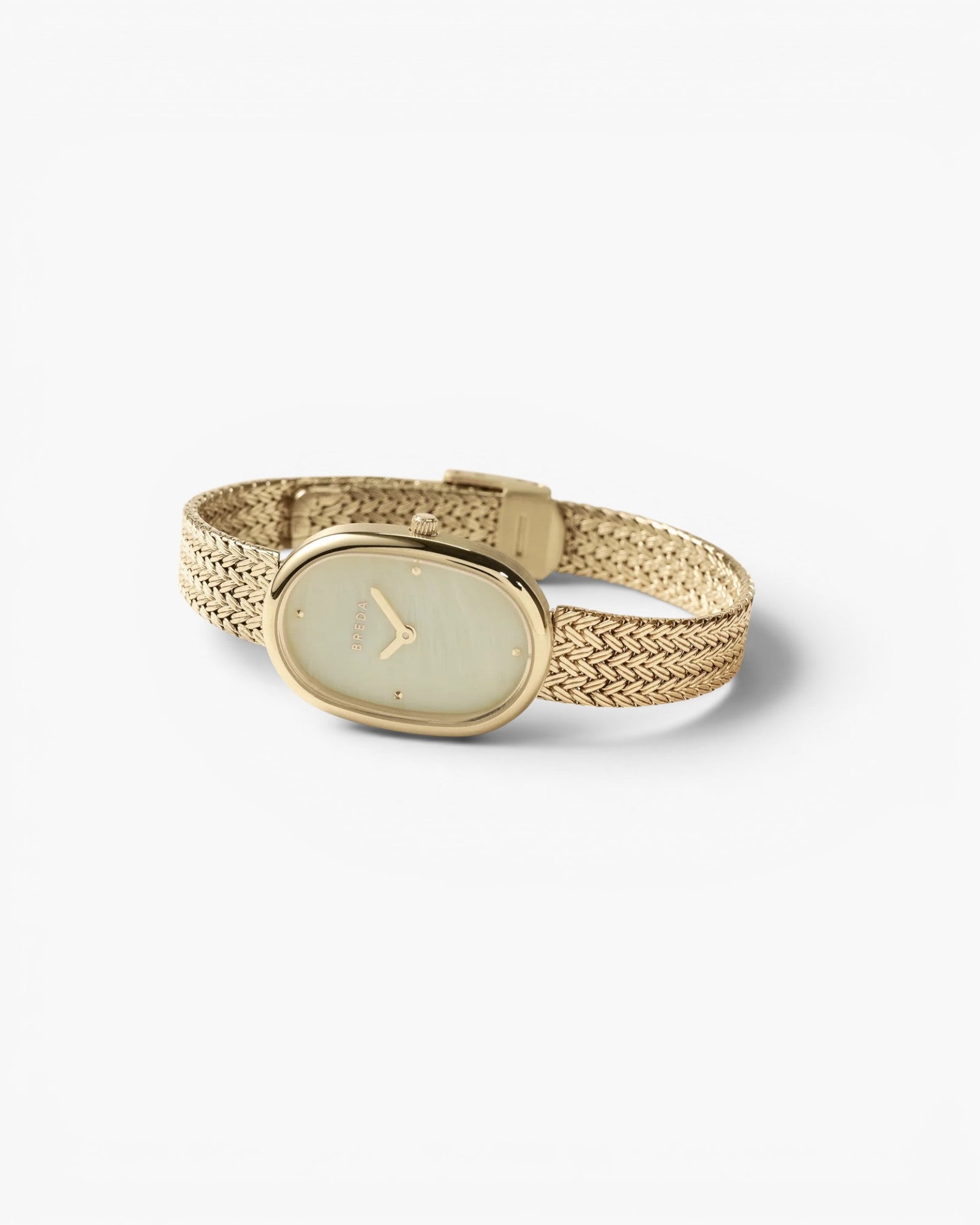 JONES + CO Jane Tethered watch featuring a gold oval case, champagne mother-of-pearl dial, and woven mesh bracelet.