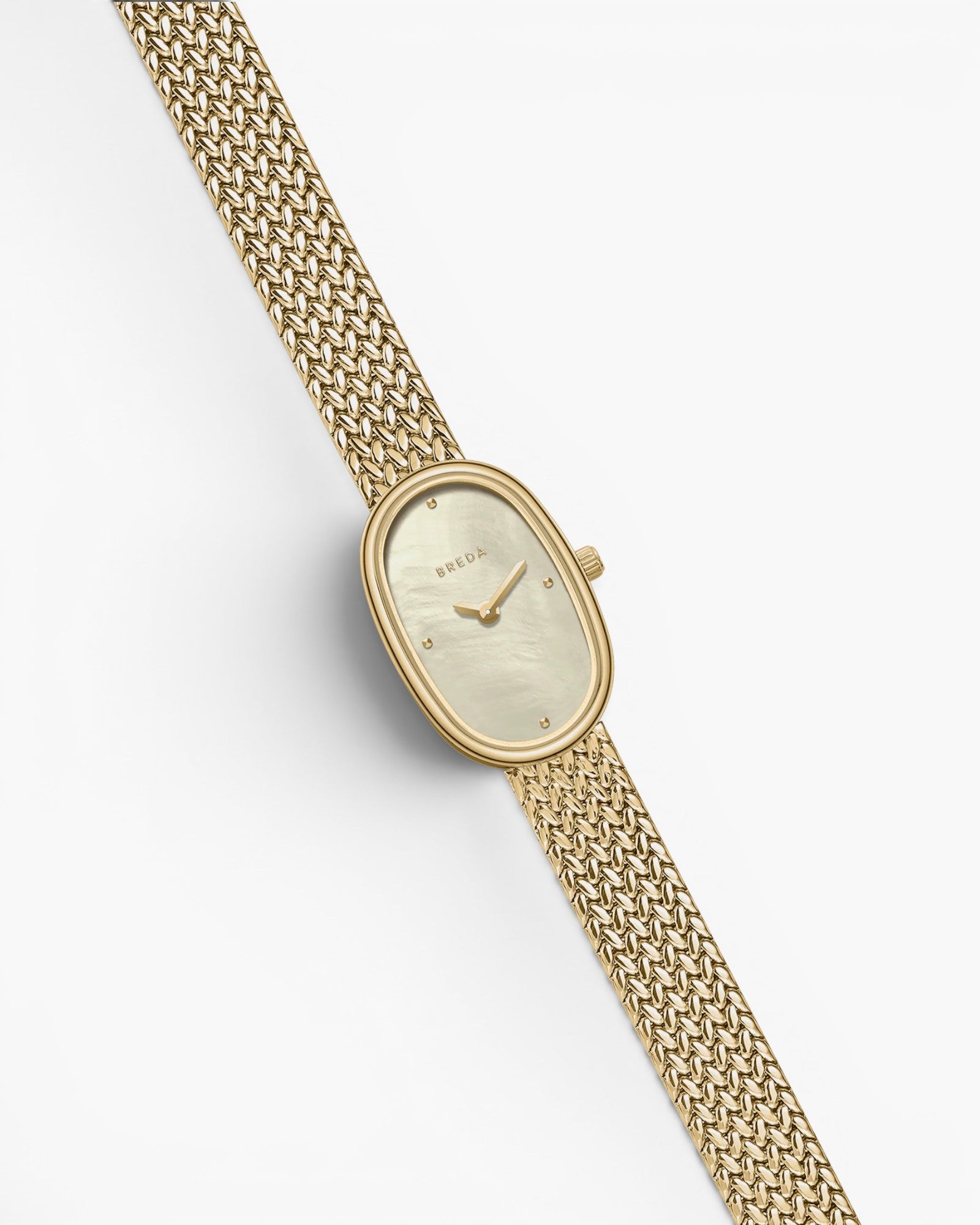 JONES + CO Jane Small watch with an 18mm gold oval case, champagne mother of pearl dial, and woven gold mesh bracelet.