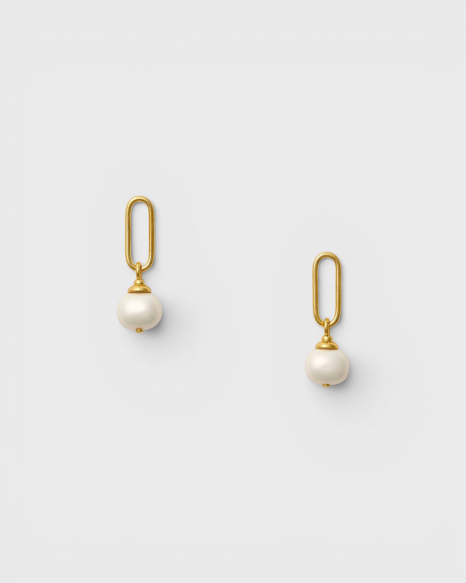 JONES + CO gold paper clip link earrings featuring luminous white pebble pearl drops on surgical steel posts.