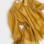 JONES + CO gold crinkled sheer button-up shirt with voluminous sleeves and pointed collar.