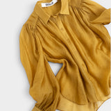 JONES + CO gold crinkled sheer button-up shirt with voluminous sleeves and pointed collar.