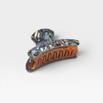 JONES + CO Grande Heirloom Claw in Blue Horn, a large hair claw clip made from Italian acetate with a marbled blue and brown tortoiseshell pattern.