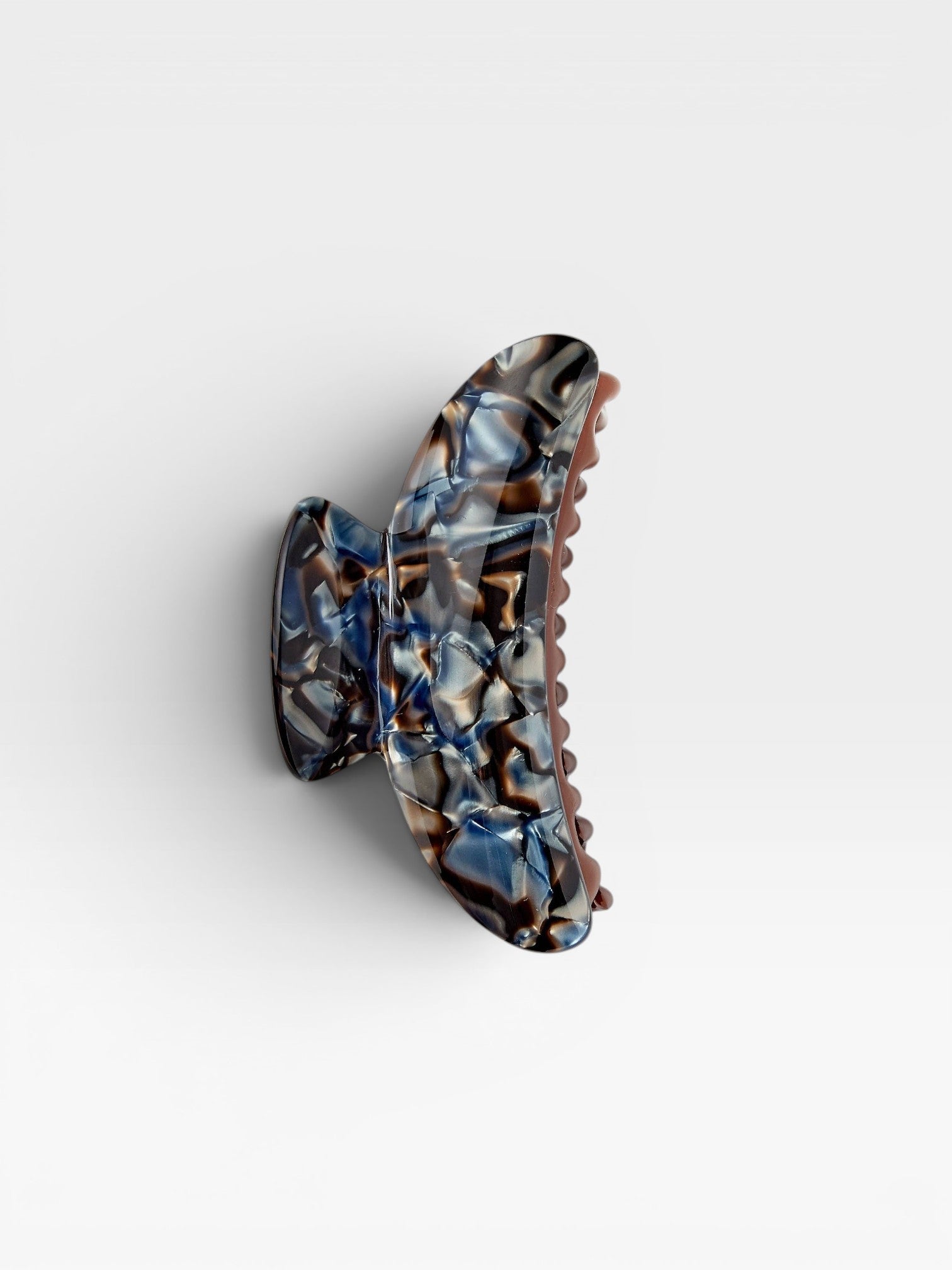 JONES + CO Grande Heirloom Claw in Blue Horn, a large hair claw clip made from Italian acetate with a marbled blue and brown pattern.