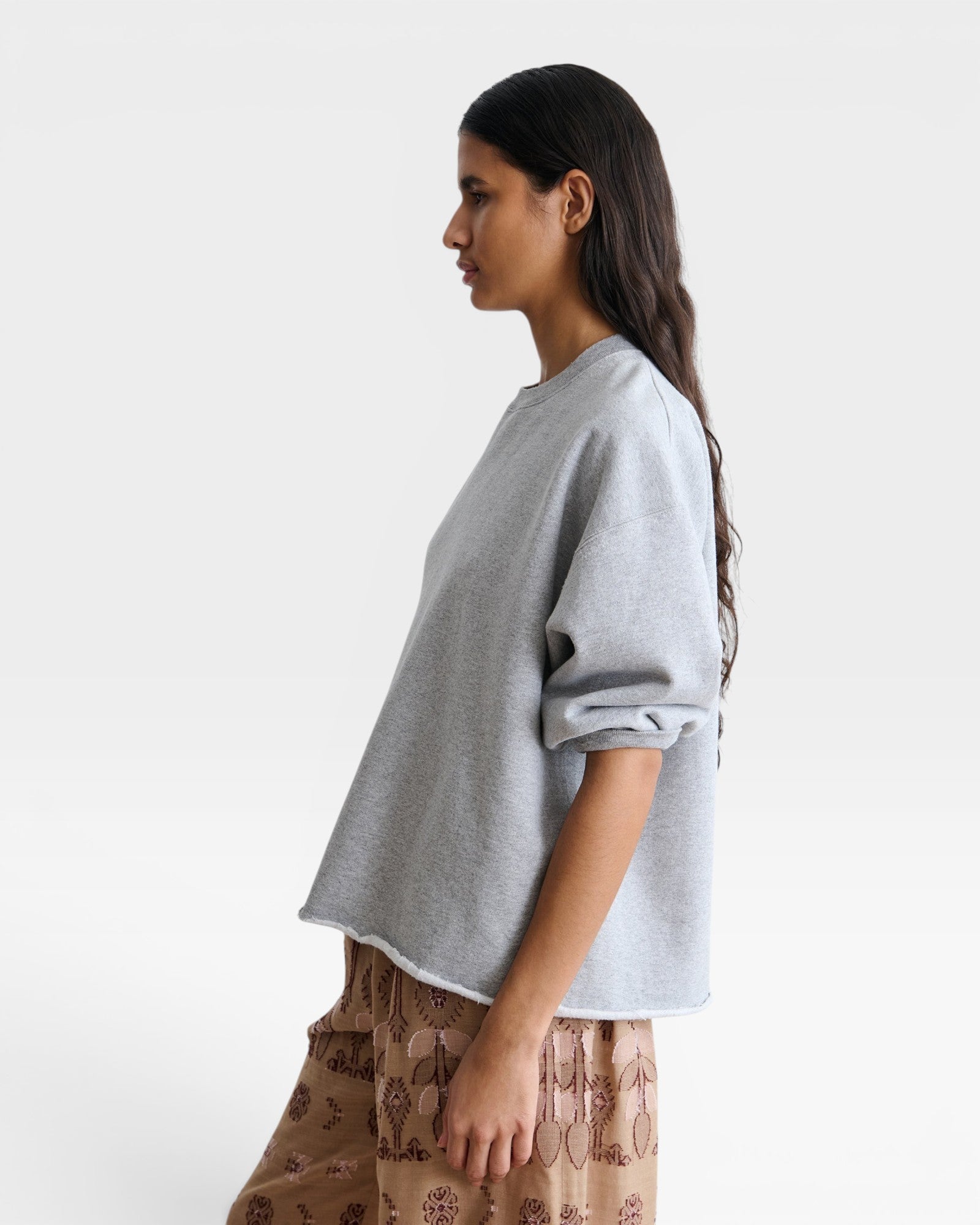 JONES + CO Rachel Comey grey crewneck sweatshirt with drop shoulders and raw edge hem worn by a model