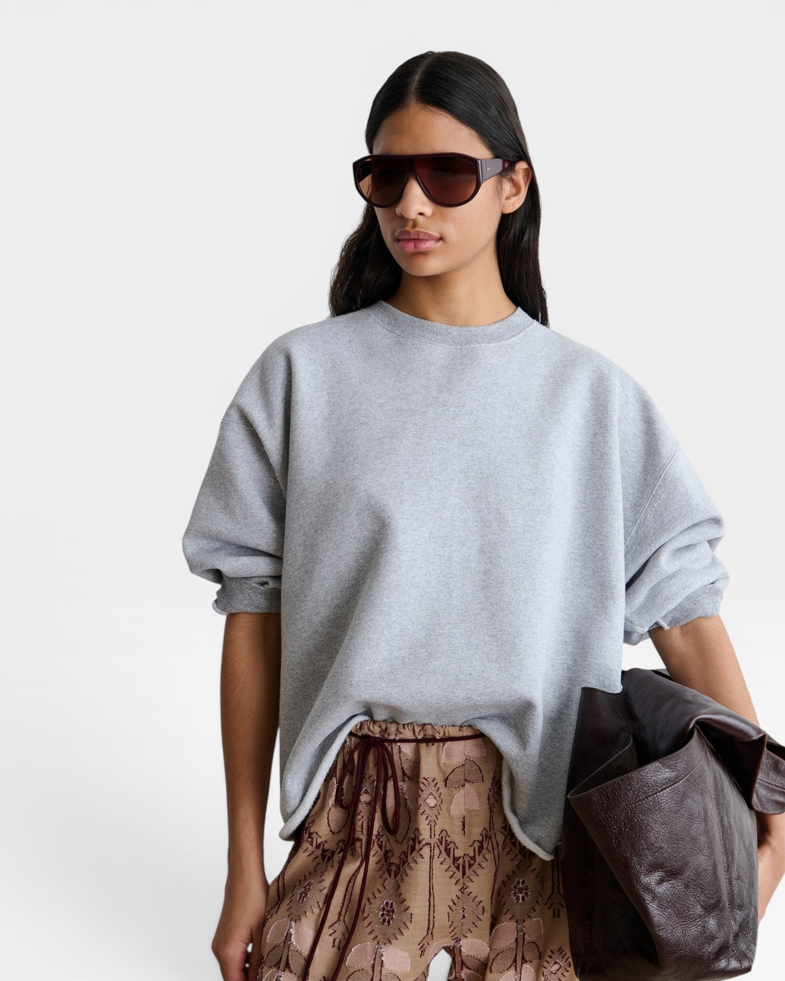 JONES + CO model wearing a grey Rachel Comey Fond crewneck sweatshirt with drop shoulders and raw edge hemline.