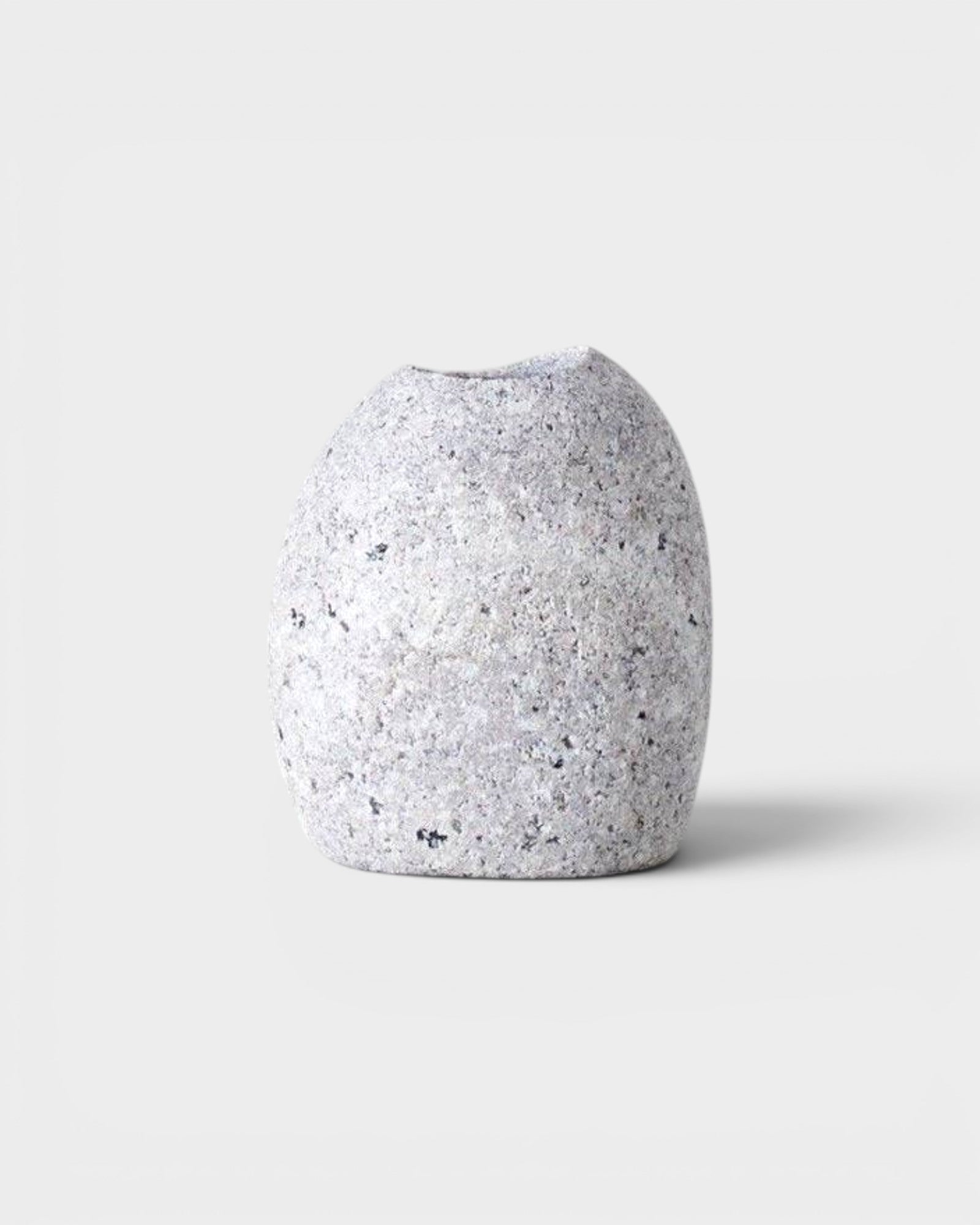JONES + CO hand-drilled grey granite beach stone match striker with a smooth, natural river rock texture.