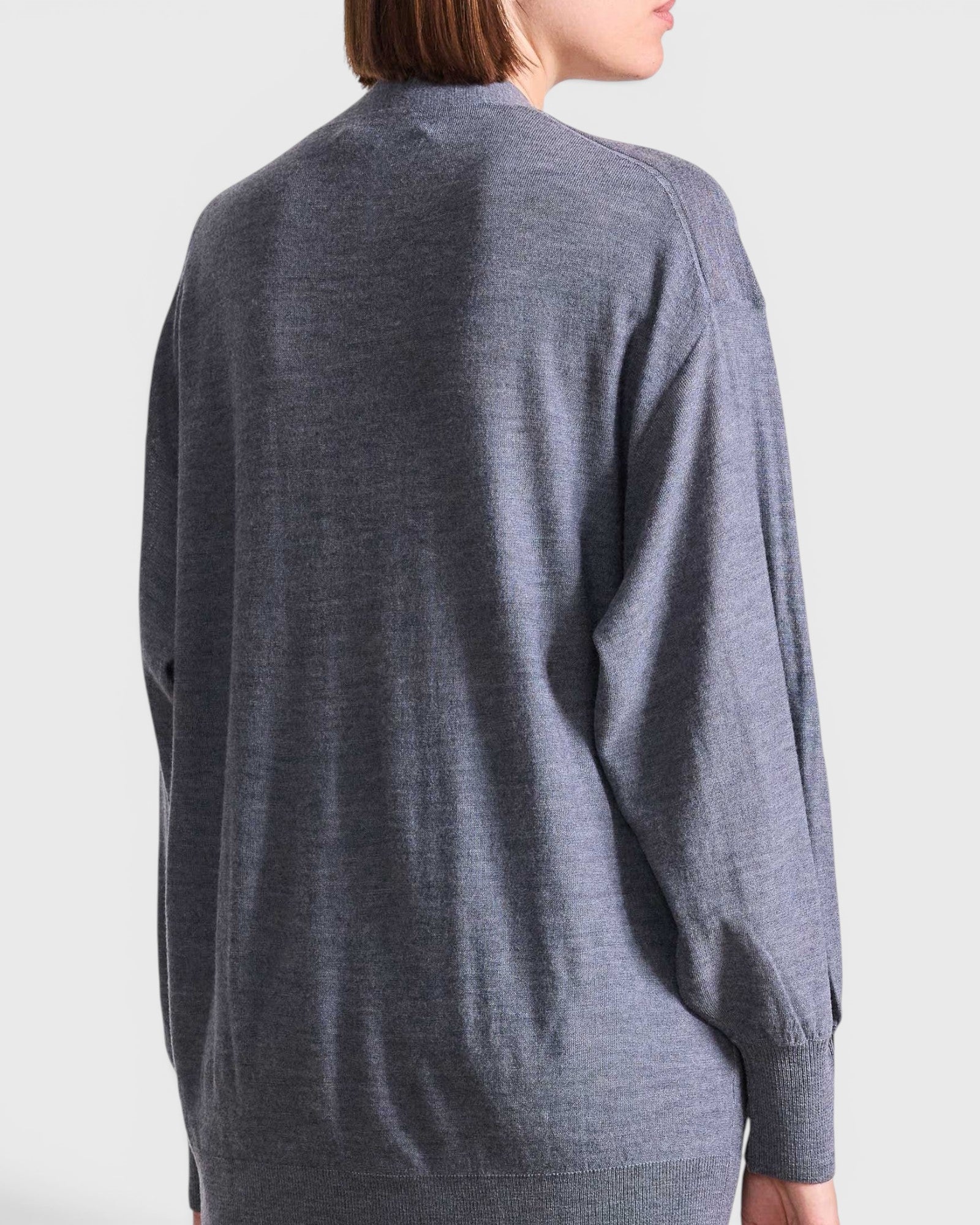 JONES + CO grey lightweight tissue cardigan worn by a model, back view showing long sleeves and relaxed fit