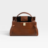 JONES + CO Gyoza pouch in brown embossed leather with a structured silhouette and gold-tone hardware clasp.