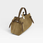 JONES + CO Gyoza pouch in fennel suede with a structured handle and side knot details on a white background.