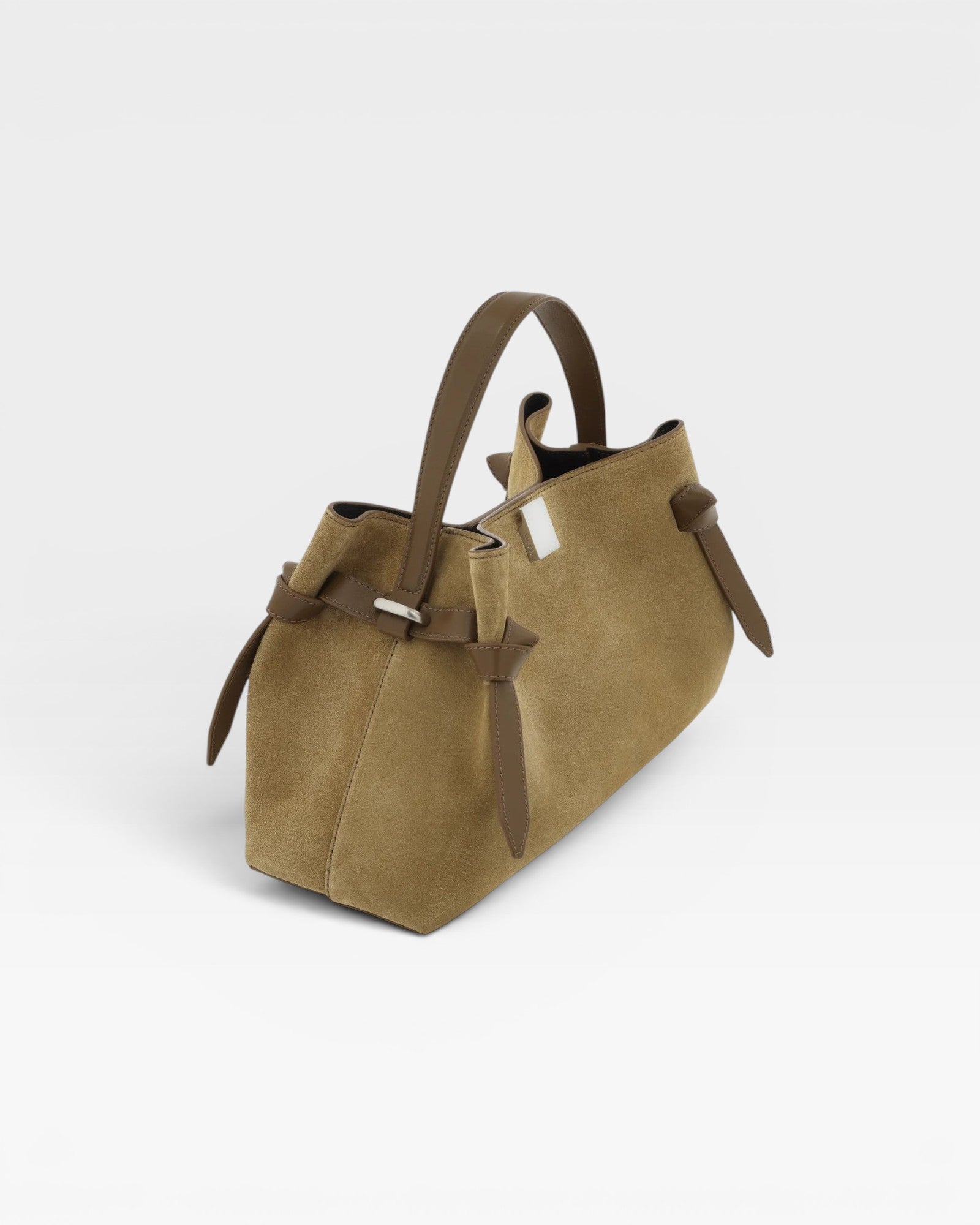 JONES + CO Gyoza pouch in fennel suede with a structured handle and side knot details on a white background.