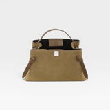 JONES + CO Gyoza pouch in fennel suede with a structured silhouette, top handle, and knotted side detailing.