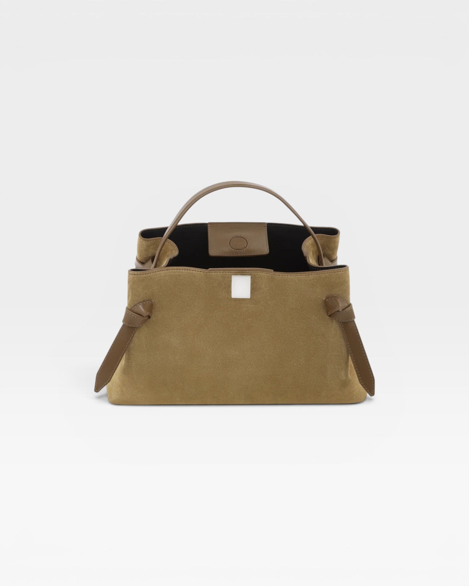 JONES + CO Gyoza pouch in fennel suede with a structured silhouette, top handle, and knotted side detailing.