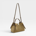 JONES + CO Gyoza pouch in fennel suede with a compact design, top handle, and adjustable shoulder strap.