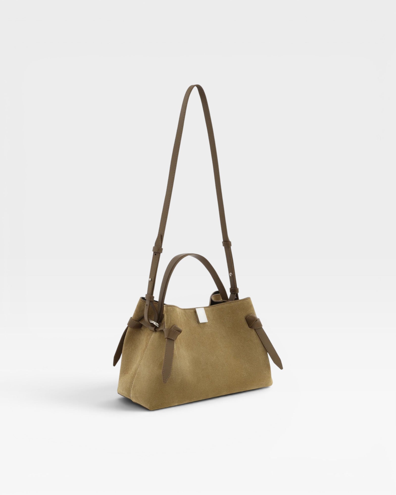 JONES + CO Gyoza pouch in fennel suede with a compact design, top handle, and adjustable shoulder strap.