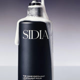 JONES + CO black matte bottle of The Hand Exfoliant with bergamot and vetiver scent, featuring pump dispenser with foam.
