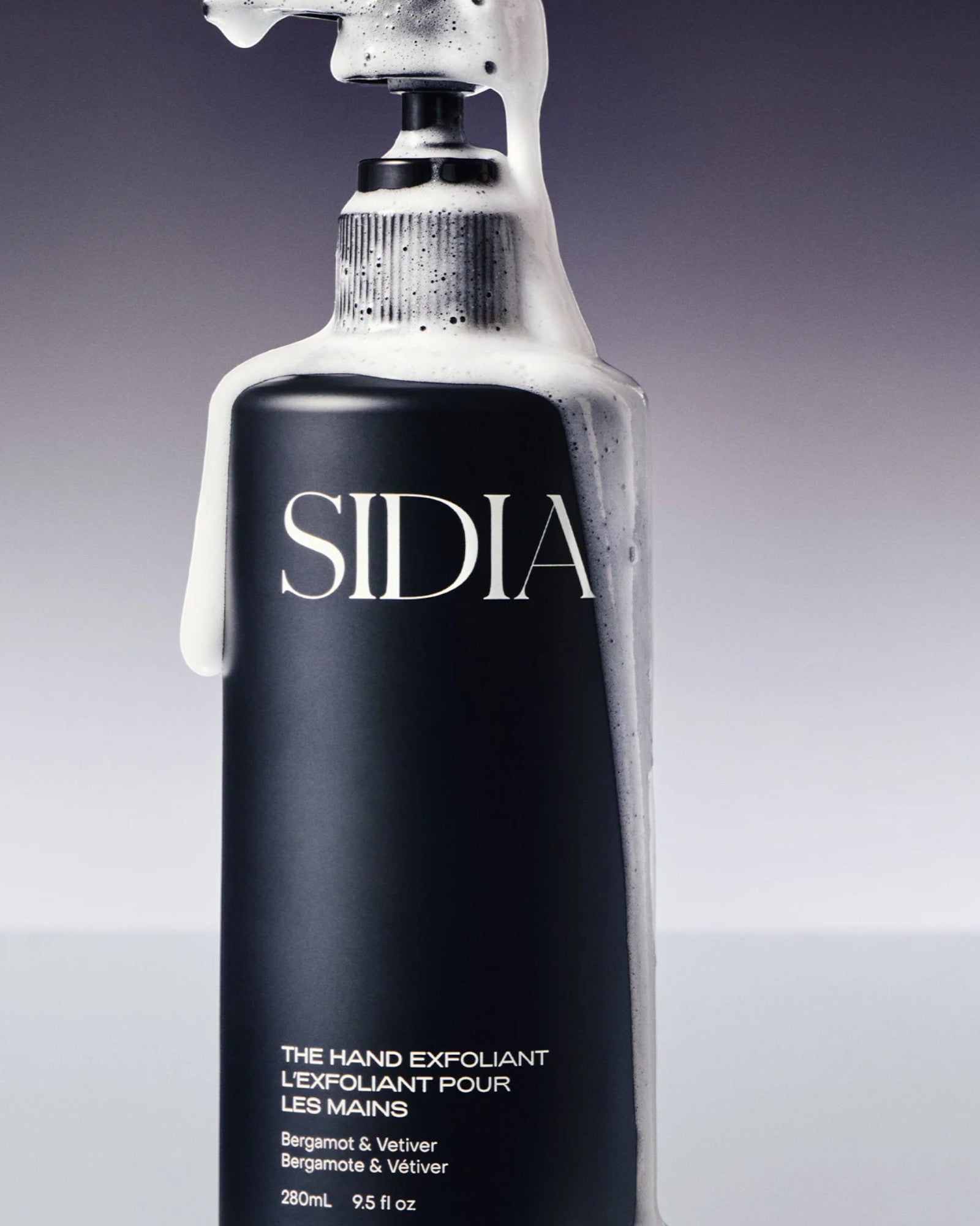 JONES + CO black matte bottle of The Hand Exfoliant with bergamot and vetiver scent, featuring pump dispenser with foam.