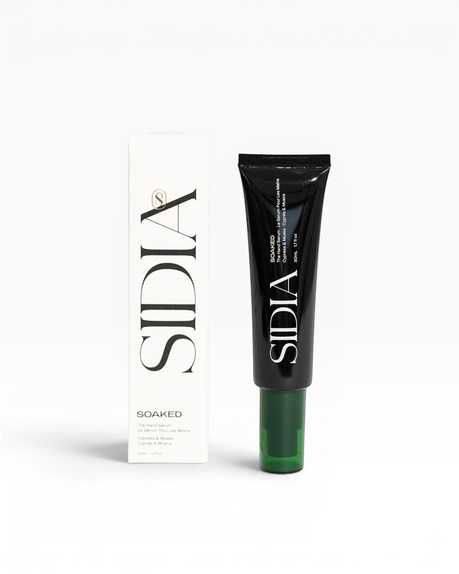 JONES + CO SOAKED Hand Serum in black tube with green cap, featuring Juniper, Cypress, and Musks scent.