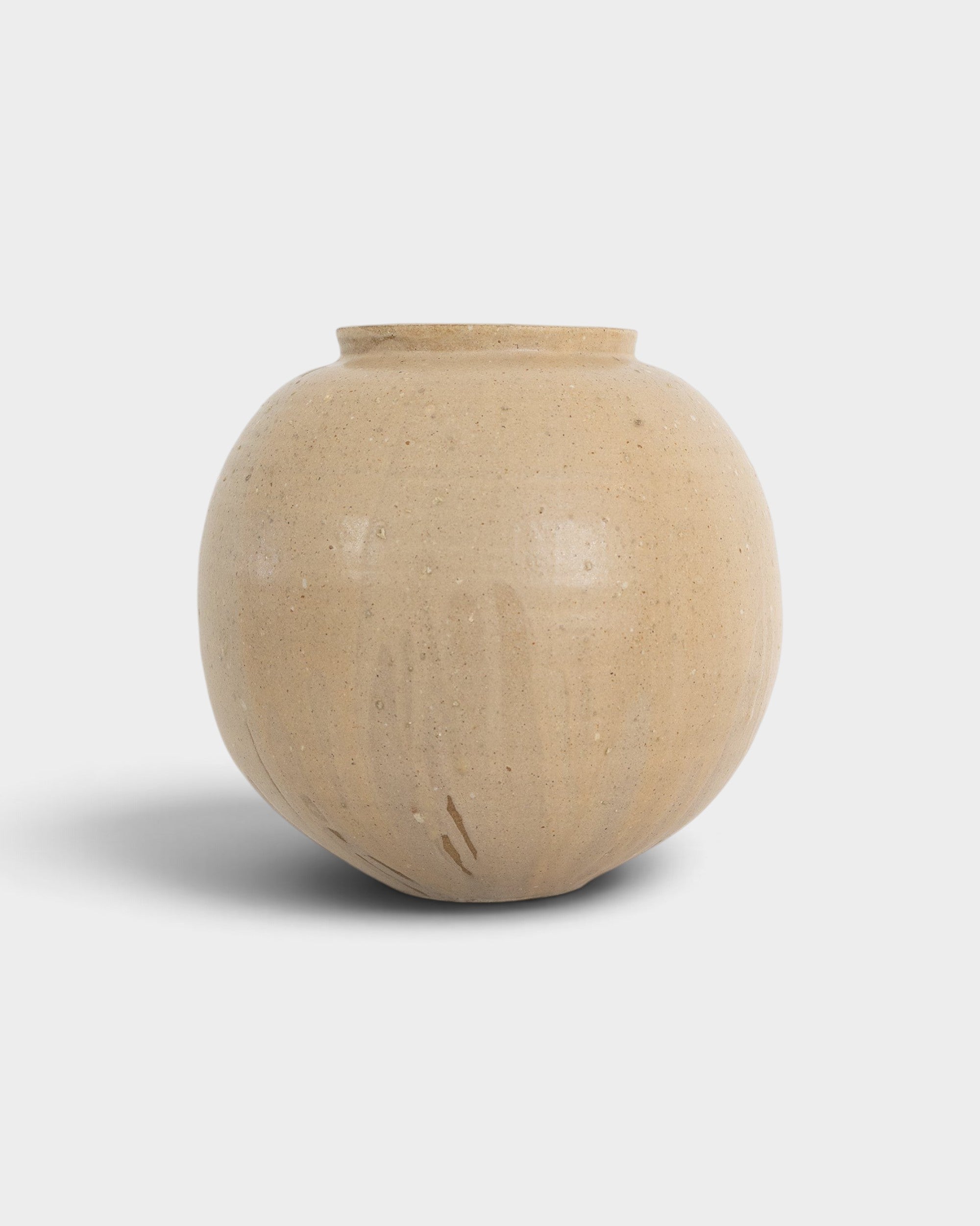 JONES + CO handthrown ceramic vase in a round, beige speckled finish, perfect as a sculptural home decor piece.