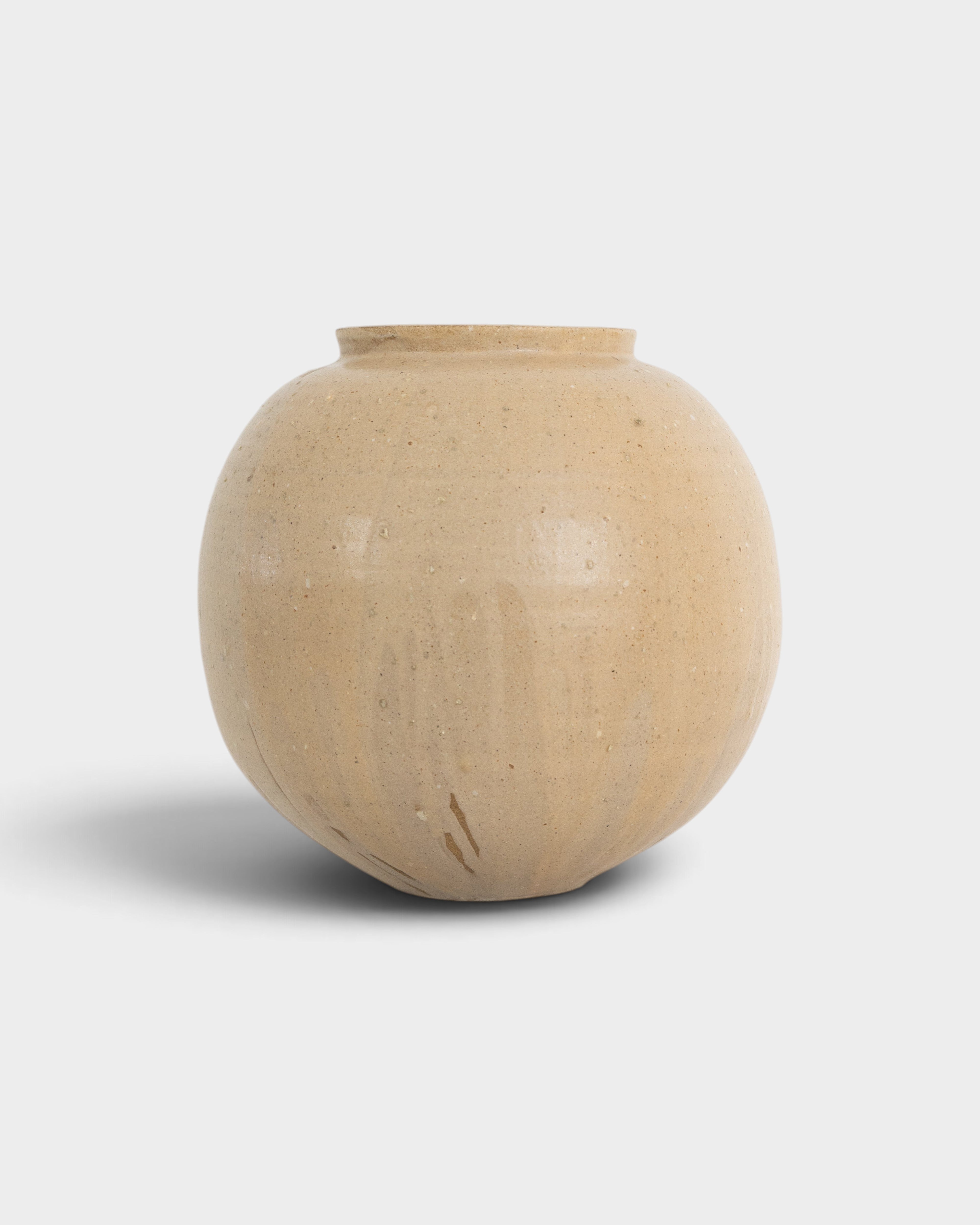 JONES + CO handthrown ceramic vase in a round, beige speckled glaze, perfect as a sculptural home decor piece.