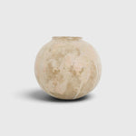 JONES + CO handthrown ceramic vase with a round, sculptural shape and textured beige and soft pink glaze finish.