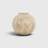 JONES + CO handthrown ceramic vase with a round, sculptural shape and textured beige and soft pink glaze finish.
