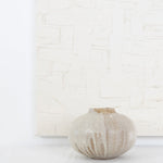 JONES + CO handthrown ceramic Vase No. 5 with a speckled beige glaze and organic rounded shape on a white surface.